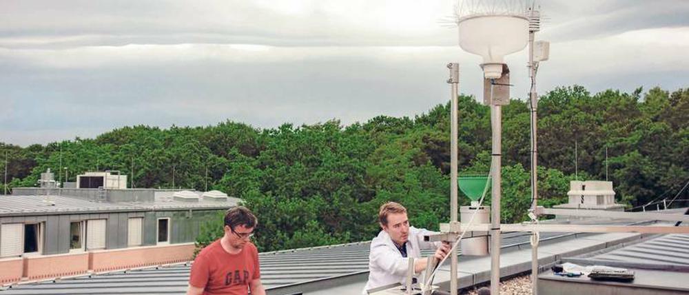 Komplexes Konstrukt. GFZ-Forscher Torsten Queisser (links) und Gunnar Pruß arbeiten an dem automatisierten Regenwassersammler.