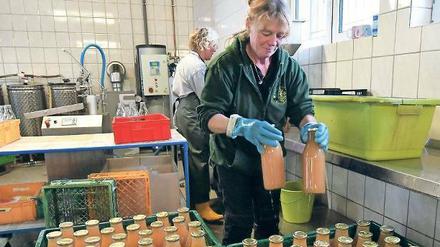 Saftig. Angelika Thierschmann stellt fertige Saftflaschen in Kisten.