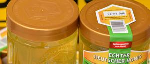 Frisch abgefüllter Robinien-Honig steht auf einem Tisch des Berufsimkers Lutz Theis aus Brandenburg.