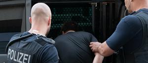 Beamte der Bundespolizei führen bei einer großangelegten Razzia gegen eine mutmaßliche Schleuser-Bande einen Mann ab.