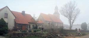 Die Dorfkirche in Raben bei Bad Belzig am Totensonntag, drinnen kondensiert die Atemluft der Gottesdienstbesucher zu Wölkchen.