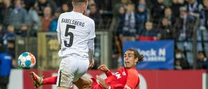 Leipzigs Yussuf Poulsen (r) geht zu Boden im Zweikampf mit Jake Wilton vom SV Babelsberg. 