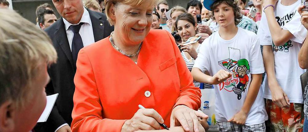 Kanzlerin zum Anfassen: Angela Merkel beim Autogrammschreiben am Tag der offenen Tür.