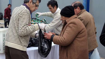 Bedürftig. Immer mehr Griechen sind auf Zuwendungen angewiesen - wie hier in einer Turnhalle in Athen, wo Arme und Obdachlose am 1. Weihnachtsfeiertag von örtlichen Behörden mit Nahrungsmitteln versorgt wurden. 