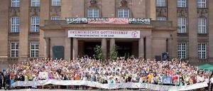 Seit zwölf Jahren wird am Pfingstmontag um 11 Uhr ein ökumenischer Open-Air-Gottesdienst mit rund 800 Menschen vor dem Rathaus Schöneberg gefeiert. Am 25. Mai kommen nun wieder evangelische, katholische, orthodoxe und freikirchliche Gemeinden aus Tempelhof und Schöneberg zum Gottesdienst zusammen. Viele Auslands- und Gastgemeinden sind dabei, es geht vielsprachig zu. Die Musik im Gottesdienst machen Chöre und Ensembles aus Schöneberg. Burkhard Bornemann, amtierender Superintendent des Kirchenkreises Berlin-Schöneberg, freut sich auf die amerikanischen, äthiopischen, koreanischen, syrischen und deutschen Gesängen: „Hier erlebe ich, dass die weltweite Christenheit mitten im Herzen von Berlin ihren Ausdruck findet! Gemeinschaft hautnah!“ Auch die Freiheitsglocke des Schöneberger Rathauses hat ihren Platz in der Liturgie - in diesem Jahr vielleicht besonders passen: Unter dem Titel „Nicht mehr fremd sein..." geht es im Gottesdienst auch um die Situation der Flüchtlinge, die in Deutschland auf Gastfreundschaft hoffen. Gemeinden tragen kurze Impulse zum Thema bei und die "Dialogpredigt" des evangelischen Pfarrers Florian Kunz und seines katholischen Kollegen Josef Wieneke widmet sich der biblischen Dimension des Fremdseins. „Das Gefühl der Fremdheit gehört zu den urmenschlichen Erfahrungen und Ängsten", sagt Isolde Böhm, Superintendentin des Kirchenkreises Tempelhof. „Doch in der Bibel ist der Fremde immer auch der Gast, dessen Aufnahme bei uns eine Gotteserfahrung sein kann." Auch Bezirksbürgermeisterin Angelika Schöttler wird am 25. Mai wieder teilnehmen: „Seit vielen Jahren bereichert der Open-Air-Gottesdienst das Pfingstfest in Tempelhof-Schöneberg. Viele Menschen unterschiedlicher Glaubensgemeinschaften treffen sich vor dem Rathaus Schöneberg, um sich gemeinsam für Frieden in der Welt und für eine Willkommenskultur gegenüber den Flüchtlingen einzusetzen. Ich werde dabei sein.“ Für Kinder gibt es während der Predigt ein kreatives Angebot, das sie dann in den Gottesdienst einbringen. Und am Ende stellen sich dann wieder alle zum Gruppenfoto auf, wie in dem Bild hier vom vergangenen Jahr.