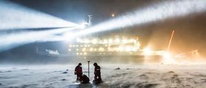 Forscher bauen eine Messstation vor der "Polarstern" auf. Die Mission will den Klimawandel in der Arktis erforschen.