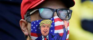 A supporter of U.S. president Donald Trump is pictured wearing a face mask and a ‘Make America Great Again’ cap as Trump supporters gather to demand a fair count of the votes of the 2020 U.S. presidential election, in Philadelphia, Pennsylvania, U.S., November 5, 2020. REUTERS/Eduardo Munoz     TPX IMAGES OF THE DAY