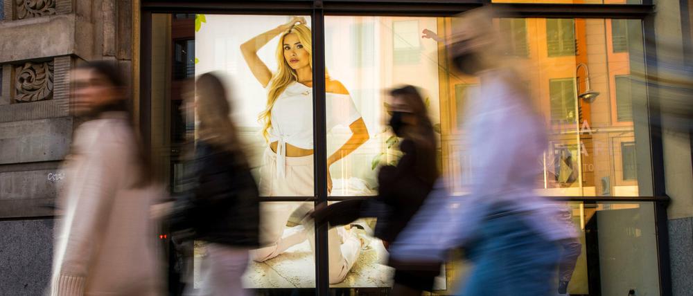 Passanten gehen an einem Modegeschäft am Hackeschen Markt vorbei. Der Textilhandel hat in Berlin besonders große Probleme.