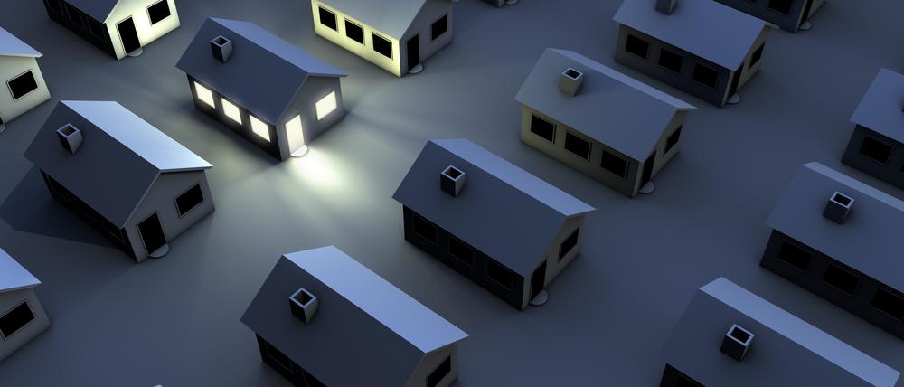 "housing estate in the night, just one house with light"