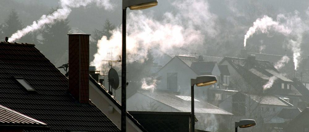 Rauch zieht aus den Schornsteinen von Wohnhäusern (Archivbild)