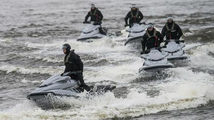 Hamburger Polizei auf Jetskis in aufgewühltem Wasser.