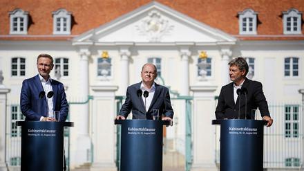 Die Laune ist besser als die Lage: Christian Lindner, Olaf Scholz und Robert Habeck (von links nach rechts) vor Schloss Meseberg.
