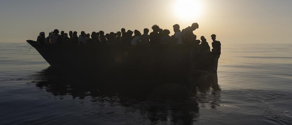 Migranten in einem Holzboot (Symbolfoto)
