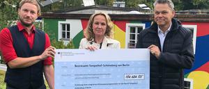 In Tempelhof überreichte Bundesumweltministerin Lemke (m.), Tempelhof-Schönebergs Bezirksbürgermeister Oltmann (r.) und dem Klimaschutzbeauftragten Fabian Krüger (l.) einen Scheck.