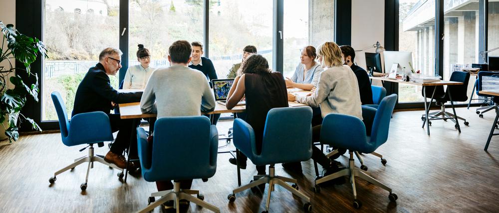 New business meeting with a group of entrepreneurs on a conference table in a modern office loft