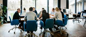 New business meeting with a group of entrepreneurs on a conference table in a modern office loft