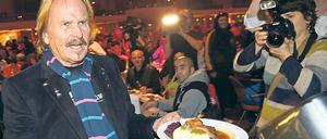 Der Sänger Frank Zander serviert am 22.12.2014 in Berlin im Hotel Estrel bei der traditionellen Weihnachtsfeier für Obdachlose und Bedürftige Gänsebraten für seine Gäste. Bereits zum 21. Mal lädt der Berliner Sänger und Entertainer Frank Zander Obdachlose zu einem Weihnachtsfest ein. Foto: Jens Kalaene/dpa (zu lbn «Frank Zander lädt Obdachlose wieder zum Gänsebraten ein» vom 08.12.2015) +++(c) dpa - Bildfunk+++