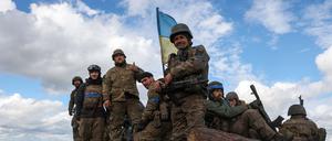 Ukrainian soldiers pose atop a personnel armoured carrier on a road near Lyman, Donetsk region on October 4, 2022, amid the Russian invasion of Ukraine. - Ukraine's President Volodymyr Zelensky said on October 2, 2022 that Lyman, a key town located in one of four Ukrainian regions annexed by Russia, had been "cleared" of Moscow's troops. (Photo by Anatolii Stepanov / AFP)