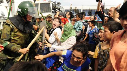 Uiguren in der chinesischen Provinz Xinjiang werden von der Polizei zurückgedrängt (Archivbild). 