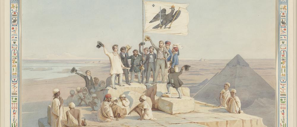 Die Mitglieder der Expedition auf der Cheops-Pyramide. Um das Bild herum sieht man in Hieroglyphen eine Widmung an König Wilhelm IV. von Richard Lepsius.
