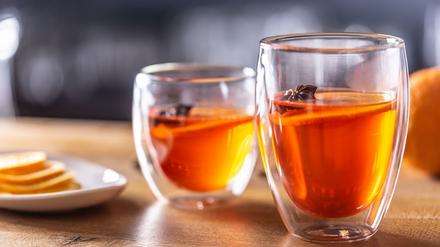 Winter drinks Hot Aperol Spritz two glass cups on a bar counter.