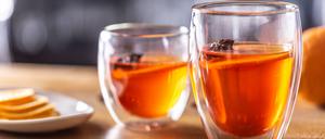 Winter drinks Hot Aperol Spritz two glass cups on a bar counter.