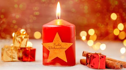 Eine Weihnachtskerze mit der Aufschrift „Frohe Weihnachten“.
