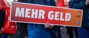 15.11.2022, Sachsen, Görlitz: Ein Mitarbeiter hält ein Schild mit der Aufschrift «Mehr Geld» in den Händen. Beschäftigte von Alstom und Siemens protestieren mit einem Warnstreik vor dem Werk von Siemens Energy. Foto: Paul Glaser/dpa-Zentralbild/dpa +++ dpa-Bildfunk +++