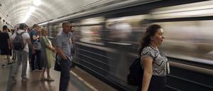 Eine Frau im Windzug einer einfahrenden U-Bahn in der russischen Hauptstadt.