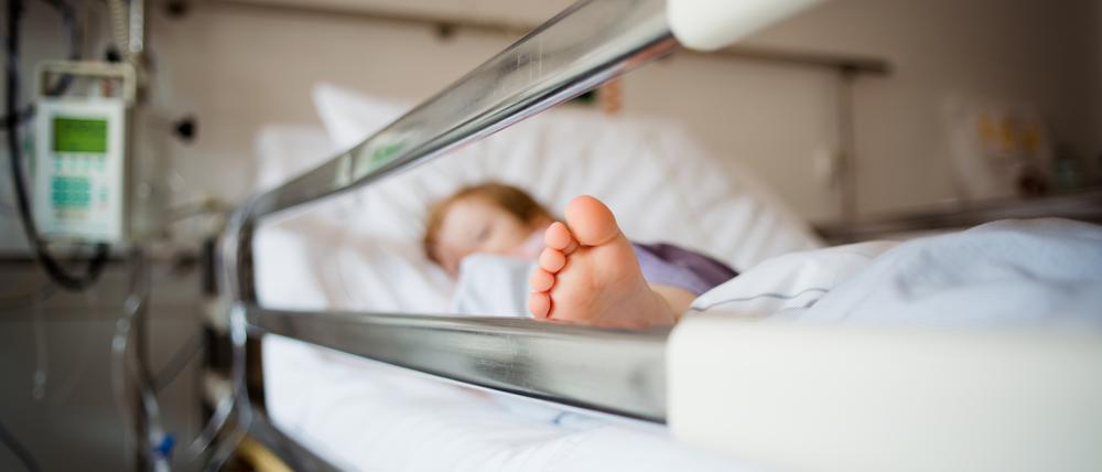 Young girl is lying in a hospital bed