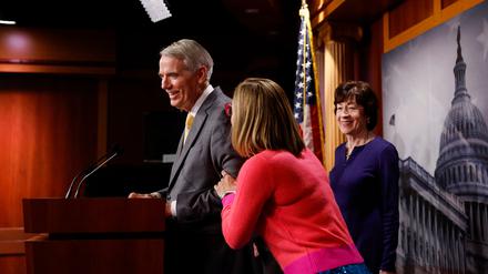 WASHINGTON, DC - NOVEMBER 29: U.S. Sen. Kyrsten Sinema (D-AZ) pats Sen. Rob Portman (R-OH) as Sen. Susan Collins (R-ME) looks on during a news conference after the Senate passed the Marriage Equality Act at the Capitol Building on November 29, 2022 in Washington, DC. In a 61-36 vote, the measure would provide federal recognition and protection for same-sex and interracial marriages.   Anna Moneymaker/Getty Images/AFP (Photo by Anna Moneymaker / GETTY IMAGES NORTH AMERICA / Getty Images via AFP)