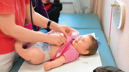 In der Kinderarztpraxis des Sana-Gesundheitszentrums „Dr. Karl-Kollwitz“ untersucht die Kinderärztin Anett Feitscher die kleine Sofia (7 Monate), während Mama Katja Richter das kleine Händchen hält.