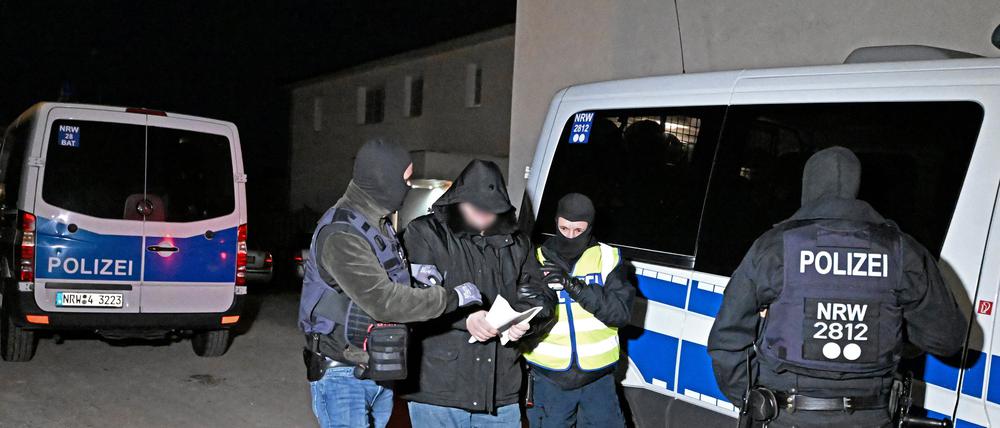 Polizisten führen bei einer Razzia im Clanmilieu in Solingen (NRW) einen Verdächtigen ab.