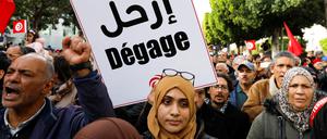 „Verschwinde“ steht auf dem Plakat der Gegner von Präsident Saied, die vor der Wahl zu einem zahnlosen Parlament in Tunis demonstrieren.