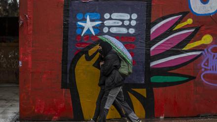  A couple walks in front of a drawing of the proposed of new constitution that was rejected in the last referendum of September 4, 2022. During a protest of high school students from public education in Santiago de Chile, on September 8, 2022. Demanding at the government improvements in the infrastructure of educational centers, more teachers, decent food, the integration of LGBTIQA  communities, also against sexist education. Santiago Chile Copyright: xClaudioxAbarcaxSandovalx 