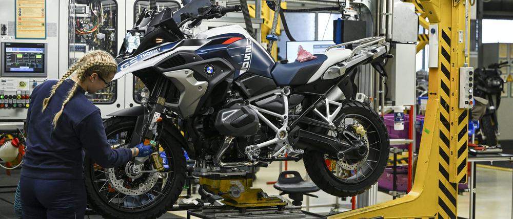 Eine Auszubildende arbeitet im Motorradwerk in Spandau an der Fertigung einer BMW R 1250 GS Trophy.