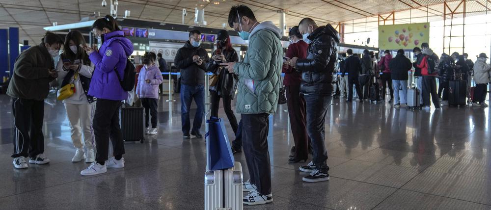 Reisende mit Mund-Nasen-Schutz in Peking.