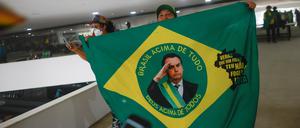 A supporter of Brazil's former President Jair Bolsonaro holds a flag depicting him during a demonstration against President Luiz Inacio Lula da Silva, in Brasilia, Brazil, January 8, 2023. REUTERS/Adriano Machado