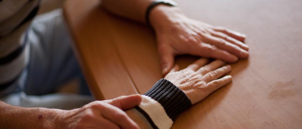 ARCHIV - 23.12.2011, ---: Ein Mann hält die Hand seiner Ehefrau, die an Alzheimer erkrankt ist. (zu dpa "BGH: Pflegegeld darf beim Pflegenden nicht gepfändet werden") Foto: Oliver Killig/dpa-Zentralbild/dpa +++ dpa-Bildfunk +++
