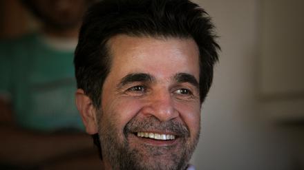 Iranian film director Jafar Panahi smiles, following his release on bail, at his home in Tehran May 25, 2010. REUTERS/Stringer/File Photo