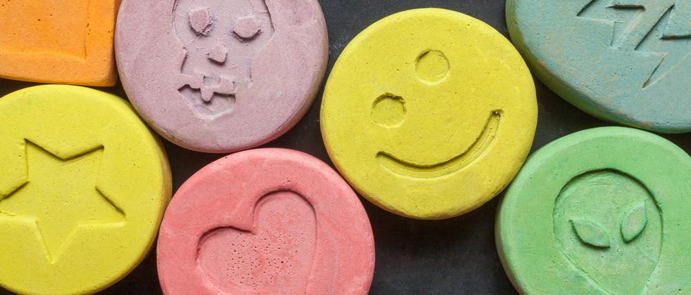 Ecstasy tablets on black background