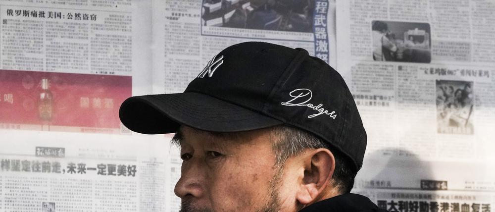 06.02.2023, China, Peking: Ein Mann reagiert nachdem er die Überschriften um den Abschuss eines mutmaßlichen chinesischen Spionageballons vor der Küste der USA las. Das Außenministerium in Peking räumte ein, dass ein weiterer, über Kolumbien entdeckter Ballon auch aus China stamme. Foto: Andy Wong/AP/dpa +++ dpa-Bildfunk +++
