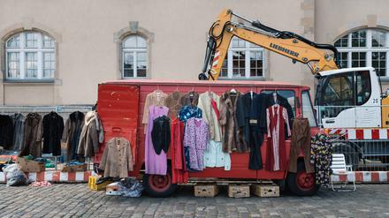 Street flea market with old used clothes Berlin, Germany - July 27, 2019: Street flea market with old second-hand clothes with hangers in a red van Copyright: xZoonar.com/jjfarquitectosx zoonar_14398712