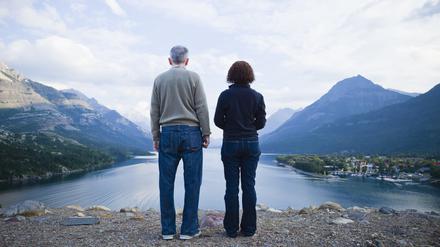 Caucasian couple standing outdoors with mountains in background