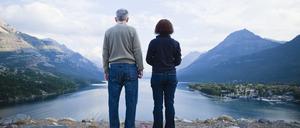 Caucasian couple standing outdoors with mountains in background