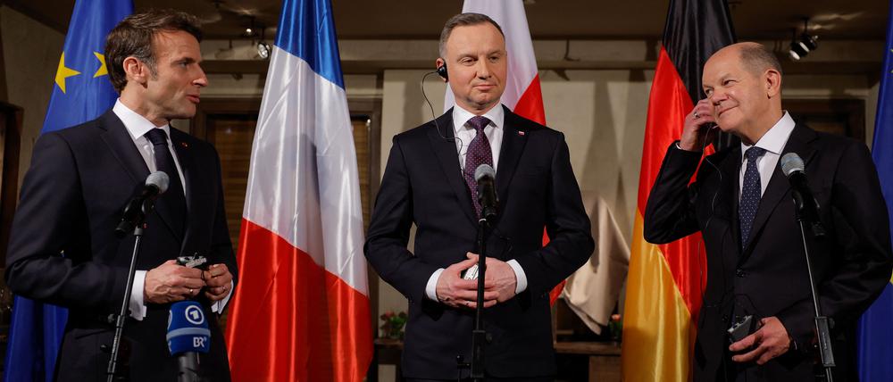 Die Präsidenten Polens, Andrzej Duda (Mitte), und Frankreichs, Emmanuel Macron, mit Bundeskanzler Olaf Scholz in München. 