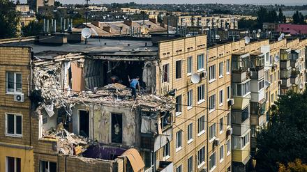 A man cleans an apartment destroyed after Russian shelling in Nikopol, Ukraine, Monday, Aug. 15, 2022. (AP Photo/Kostiantyn Liberov)