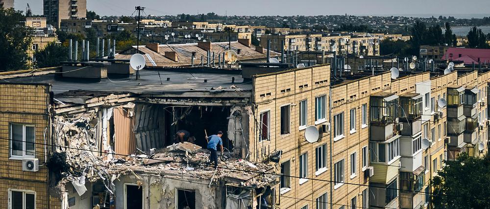 A man cleans an apartment destroyed after Russian shelling in Nikopol, Ukraine, Monday, Aug. 15, 2022. (AP Photo/Kostiantyn Liberov)
