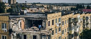 A man cleans an apartment destroyed after Russian shelling in Nikopol, Ukraine, Monday, Aug. 15, 2022. (AP Photo/Kostiantyn Liberov)