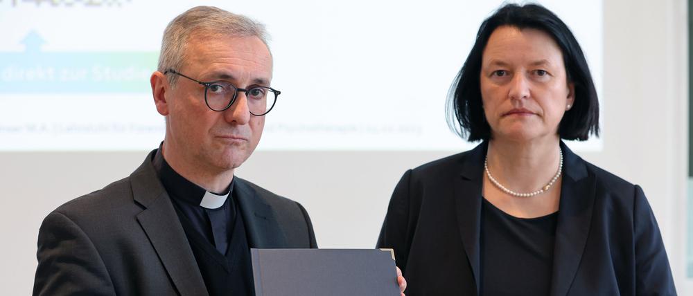 Stefan Heße (l), Erzbischof von Hamburg, nimmt das Gutachten zu sexuellem Missbrauch in der katholischen Kirche in Mecklenburg entgegen.